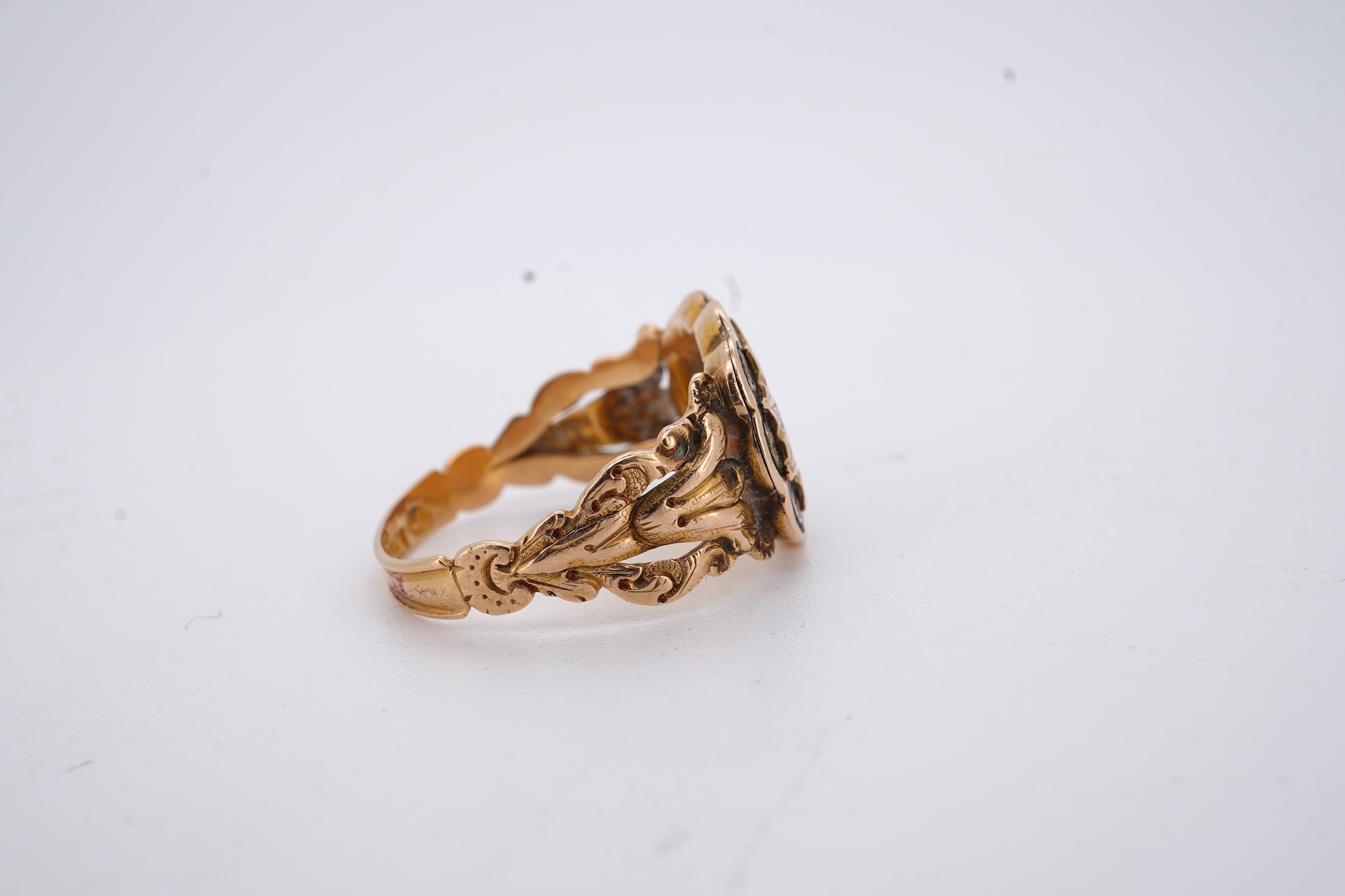 A William IV 18ct gold and black enamel 'In Memory' mourning ring, with hair beneath a central glazed panel, size N, gross weight 2.8 grams.